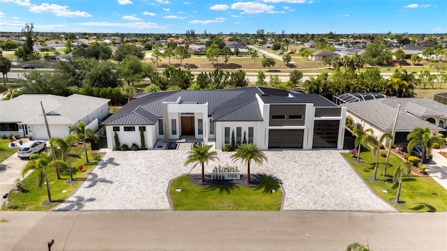 1108 SW 24th St, Cape Coral, FL 33991 - view of front facade with decorative driveway, an attached garage, a residential view, and metal roof