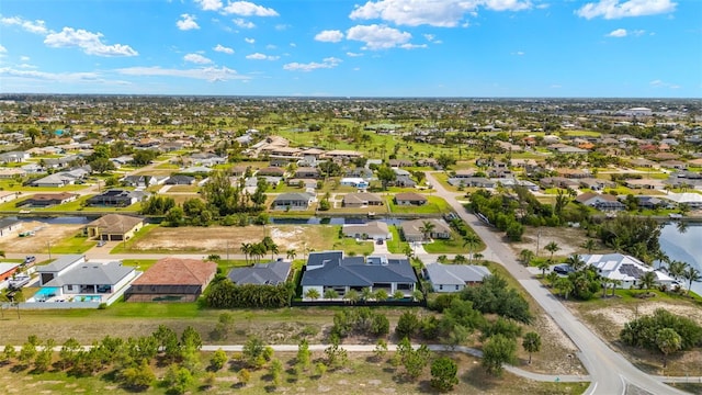 1108 SW 24th St, Cape Coral, FL 33991 - aerial perspective of suburban area with a large body of water