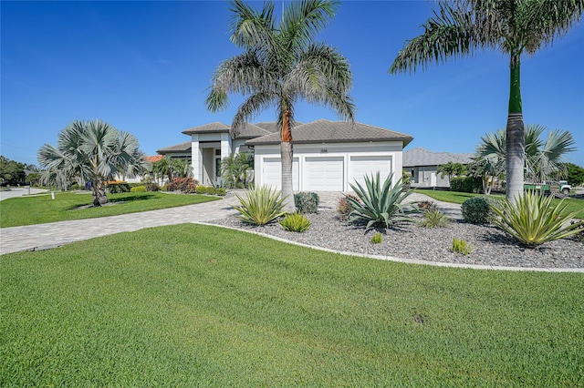 1801 Los Alamos Dr, Punta Gorda, FL 33950 - view of front facade featuring driveway, a front yard, a garage, and stucco siding