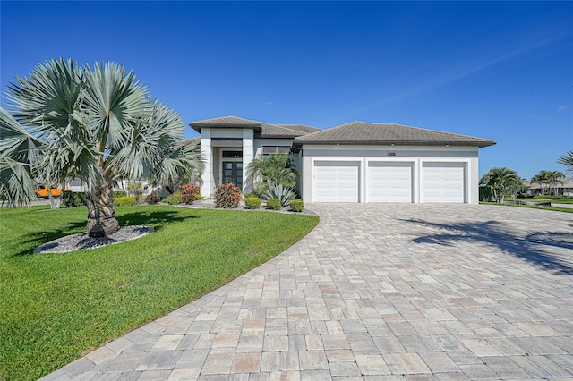 1801 Los Alamos Dr, Punta Gorda, FL 33950 - view of front facade featuring decorative driveway, an attached garage, a front yard, and stucco siding