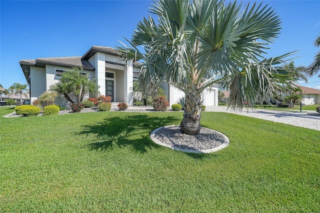 1801 Los Alamos Dr, Punta Gorda, FL 33950 - view of property hidden behind natural elements with stucco siding, a front lawn, driveway, and a garage