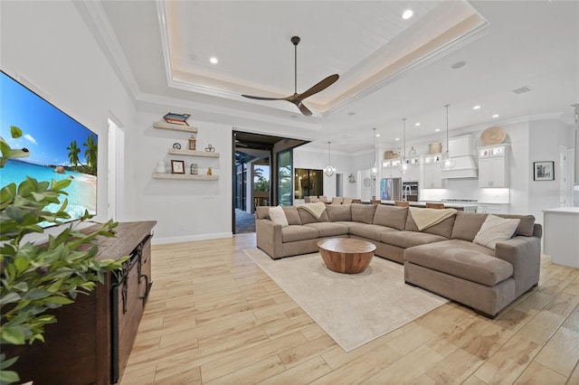 1801 Los Alamos Dr, Punta Gorda, FL 33950 - living area featuring a raised ceiling, crown molding, ceiling fan, light wood finished floors, and recessed lighting