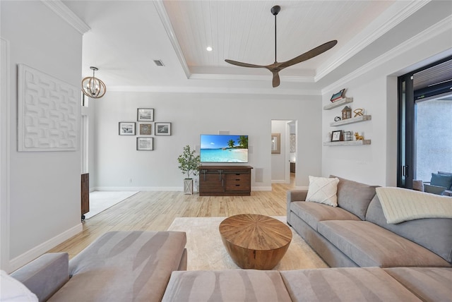 1801 Los Alamos Dr, Punta Gorda, FL 33950 - living room with a raised ceiling, light wood-style flooring, ornamental molding, a ceiling fan, and a chandelier