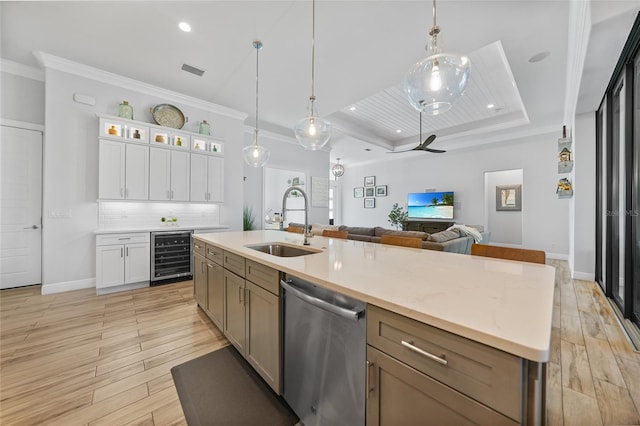 1801 Los Alamos Dr, Punta Gorda, FL 33950 - kitchen featuring dishwasher, wine cooler, a raised ceiling, white cabinets, and open floor plan