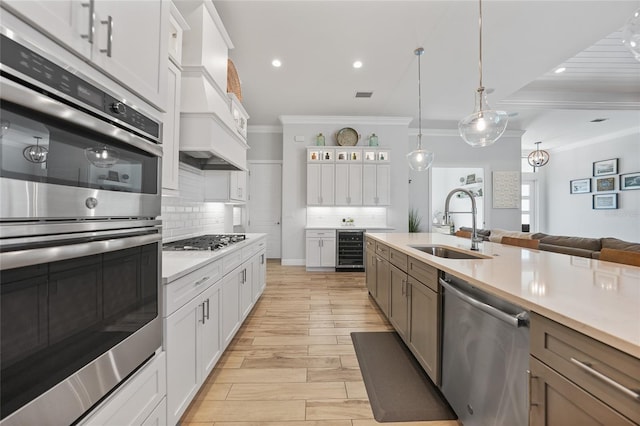 1801 Los Alamos Dr, Punta Gorda, FL 33950 - kitchen featuring stainless steel appliances, beverage cooler, ornamental molding, decorative backsplash, and light countertops