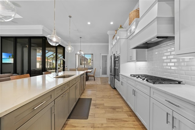 1801 Los Alamos Dr, Punta Gorda, FL 33950 - kitchen with appliances with stainless steel finishes, custom range hood, decorative backsplash, decorative light fixtures, and white cabinets