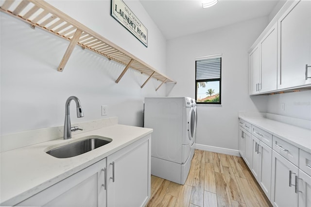 1801 Los Alamos Dr, Punta Gorda, FL 33950 - laundry area with cabinet space, washer and clothes dryer, and light wood-type flooring