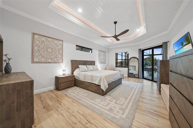 1801 Los Alamos Dr, Punta Gorda, FL 33950 - bedroom featuring a raised ceiling, light wood finished floors, ornamental molding, access to exterior, and a ceiling fan