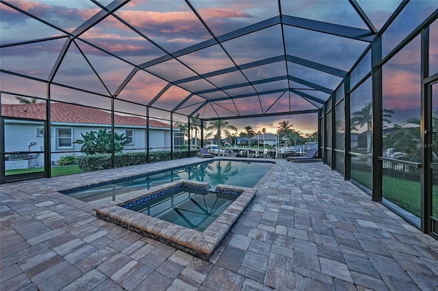 1801 Los Alamos Dr, Punta Gorda, FL 33950 - pool at dusk with a patio, a pool with connected hot tub, and a lanai