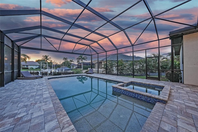 1801 Los Alamos Dr, Punta Gorda, FL 33950 - pool at dusk with a pool with connected hot tub, a patio area, and a lanai