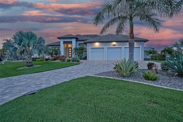 1801 Los Alamos Dr, Punta Gorda, FL 33950 - view of front of house with decorative driveway, an attached garage, a front yard, and stucco siding