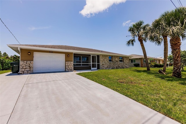 444 Edgewood Rd, Venice, FL 34293 - ranch-style house featuring stone siding, a garage, driveway, and a front lawn