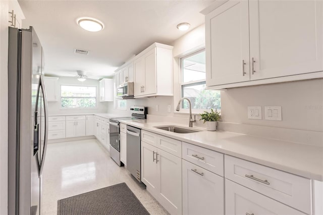 444 Edgewood Rd, Venice, FL 34293 - kitchen featuring stainless steel appliances, white cabinets, a ceiling fan, and light countertops