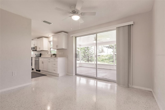 444 Edgewood Rd, Venice, FL 34293 - kitchen with ceiling fan, stainless steel microwave, range, white cabinets, and light countertops