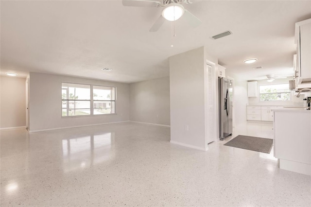444 Edgewood Rd, Venice, FL 34293 - unfurnished living room featuring a ceiling fan and dark aggregate flooring