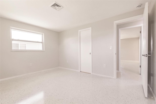 444 Edgewood Rd, Venice, FL 34293 - unfurnished bedroom with dark speckled floor and baseboards