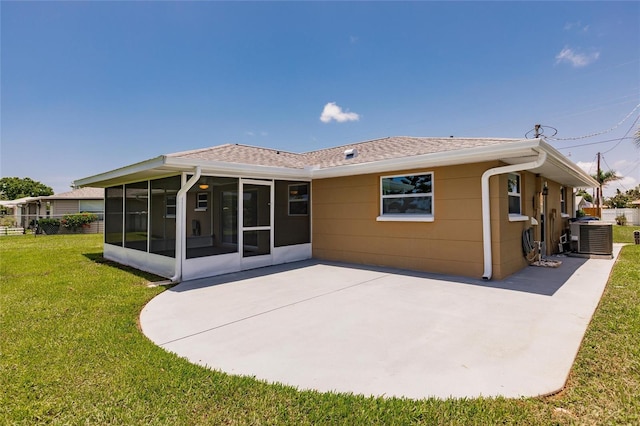 444 Edgewood Rd, Venice, FL 34293 - rear view of house with a sunroom, roof with shingles, a patio, and a lawn