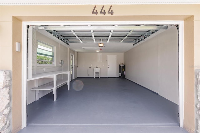 444 Edgewood Rd, Venice, FL 34293 - garage featuring water heater and a garage door opener