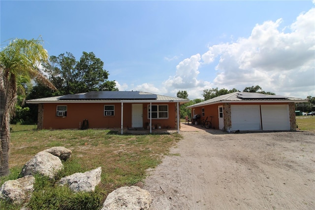 28024 Cleveland Ave, Punta Gorda, FL 33982 - single story home featuring roof mounted solar panels, a garage, and an outbuilding