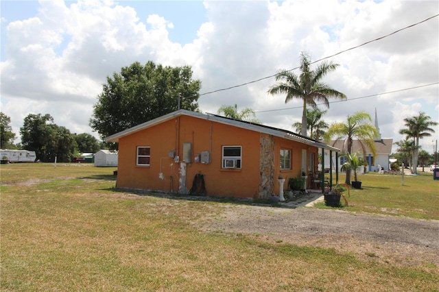 28024 Cleveland Ave, Punta Gorda, FL 33982 - view of side of home with a lawn and stucco siding