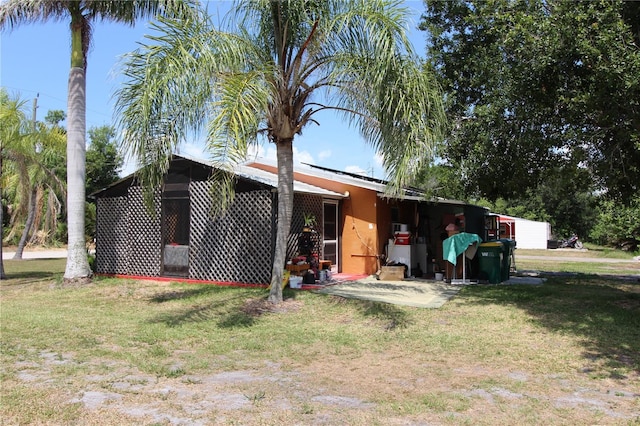28024 Cleveland Ave, Punta Gorda, FL 33982 - view of home's exterior featuring a yard and stucco siding