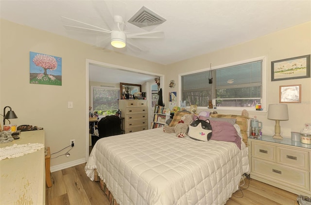 4511 Wilkinson Rd, Sarasota, FL 34233 - bedroom featuring light wood finished floors, a ceiling fan, and baseboards