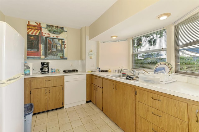 4511 Wilkinson Rd, Sarasota, FL 34233 - kitchen featuring freestanding refrigerator, a sink, light countertops, and light tile patterned floors