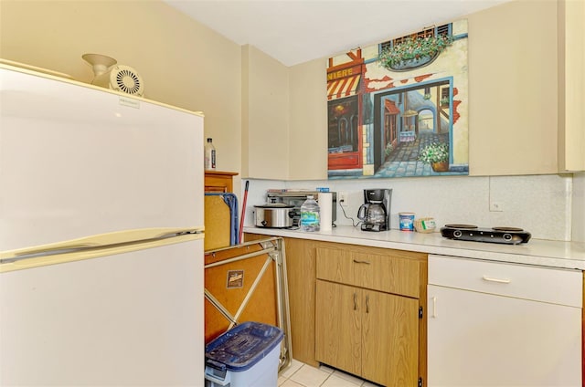 4511 Wilkinson Rd, Sarasota, FL 34233 - kitchen with freestanding refrigerator, light countertops, and light tile patterned floors