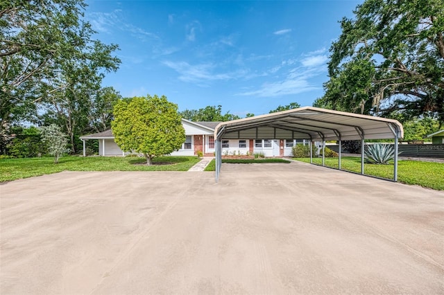 4511 Wilkinson Rd, Sarasota, FL 34233 - view of parking with a detached carport and driveway
