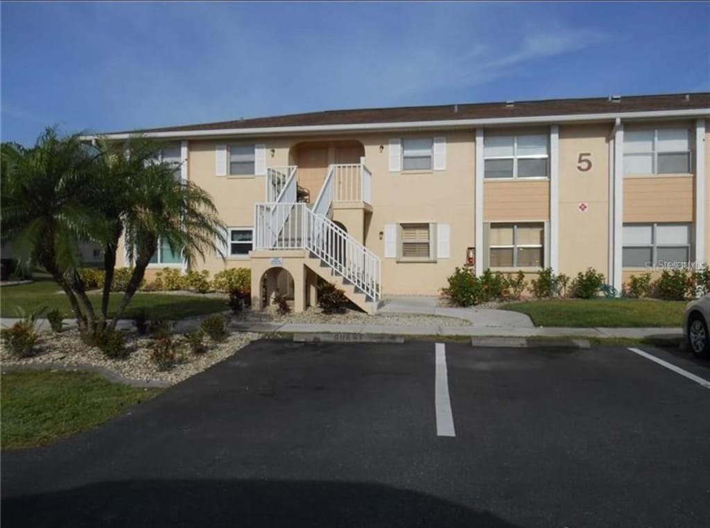 25050 Sandhill Blvd Unit A2, Punta Gorda, FL 33983 - view of property with uncovered parking and stairs