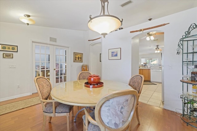 3322 Hampton St, Port Charlotte, FL 33948 - dining area with ceiling fan, arched walkways, light wood-style floors, and french doors