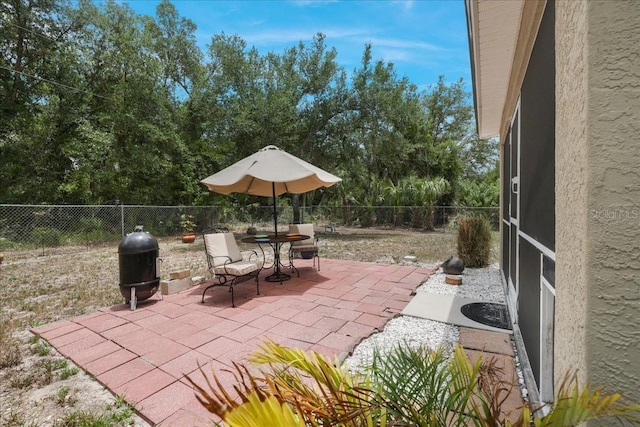 3322 Hampton St, Port Charlotte, FL 33948 - fenced backyard with a patio area, view of wooded area, and outdoor dining area