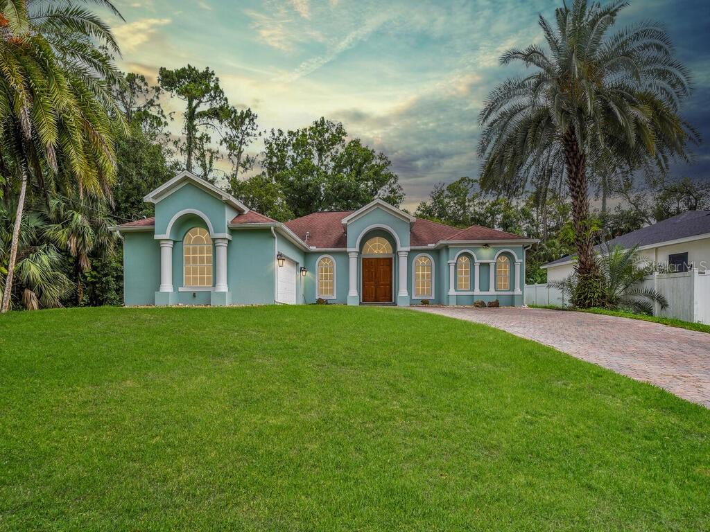 3847 Hopevale St, Fort Myers, FL 33905 - mediterranean / spanish-style home featuring driveway, stucco siding, and an attached garage