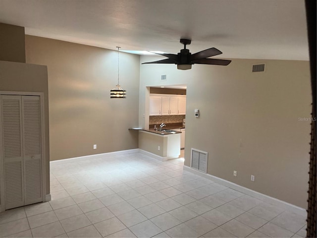 3300 Loveland Blvd Unit 602, Punta Gorda, FL 33980 - unfurnished living room featuring a ceiling fan, light tile patterned flooring, and vaulted ceiling