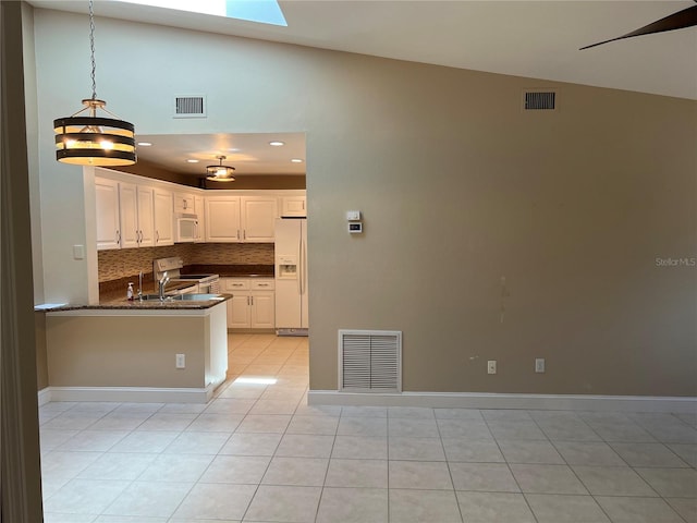 3300 Loveland Blvd Unit 602, Punta Gorda, FL 33980 - kitchen featuring white appliances, light tile patterned flooring, tasteful backsplash, white cabinets, and recessed lighting