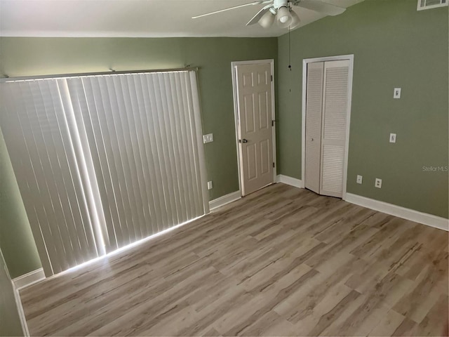 3300 Loveland Blvd Unit 602, Punta Gorda, FL 33980 - unfurnished bedroom featuring wood finished floors, a closet, and ceiling fan