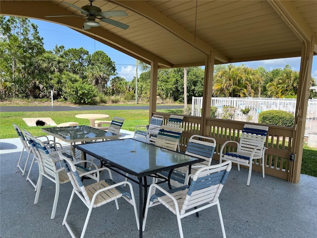 3300 Loveland Blvd Unit 602, Punta Gorda, FL 33980 - view of patio / terrace with outdoor dining space, ceiling fan, and view of wooded area