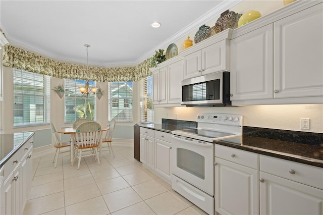 25555 Heritage Lake Blvd Unit 27, Punta Gorda, FL 33983 - kitchen featuring white electric range oven, stainless steel microwave, a chandelier, ornamental molding, and light tile patterned floors