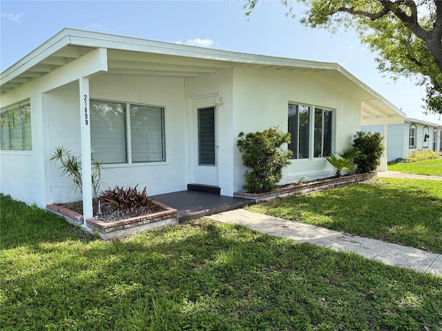 21899 Cellini Ave, Port Charlotte, FL 33952 - view of front of home featuring a front lawn and stucco siding