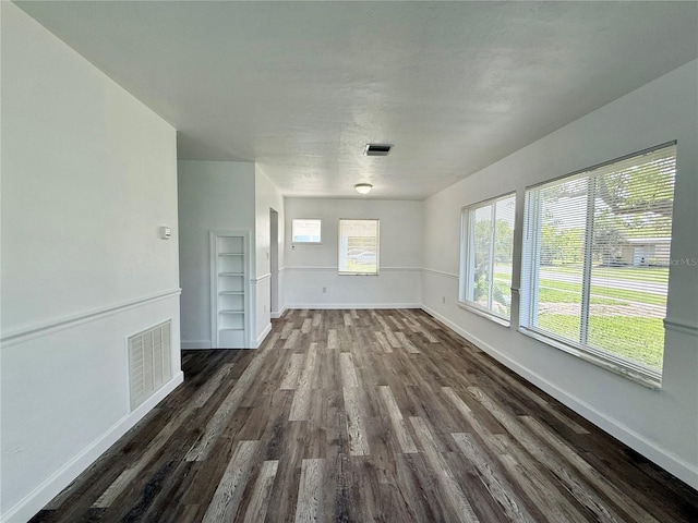 21899 Cellini Ave, Port Charlotte, FL 33952 - spare room with dark wood-type flooring and baseboards