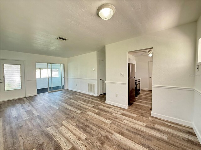21899 Cellini Ave, Port Charlotte, FL 33952 - spare room with wood finished floors, a ceiling fan, and a textured ceiling