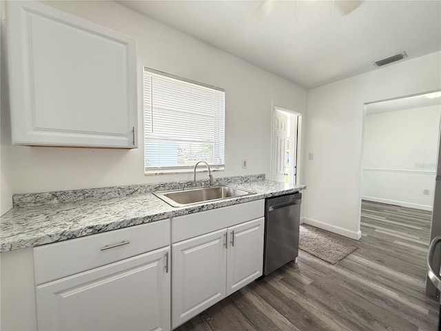 21899 Cellini Ave, Port Charlotte, FL 33952 - kitchen with stainless steel dishwasher, dark wood-type flooring, white cabinetry, and light countertops