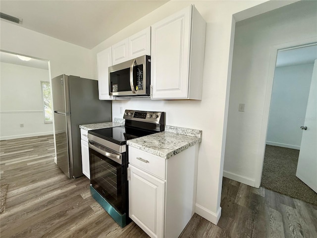 21899 Cellini Ave, Port Charlotte, FL 33952 - kitchen featuring stainless steel appliances, dark wood-style flooring, white cabinetry, and light stone counters