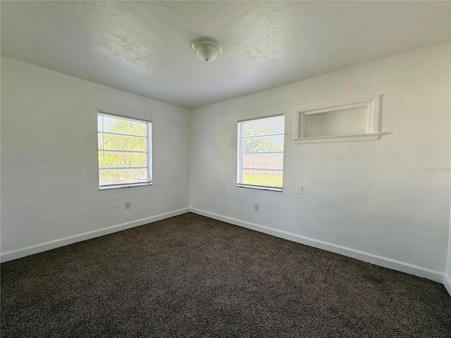 21899 Cellini Ave, Port Charlotte, FL 33952 - empty room with healthy amount of natural light and dark carpet