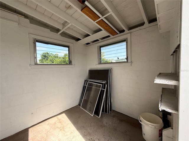 21899 Cellini Ave, Port Charlotte, FL 33952 - bathroom with healthy amount of natural light, unfinished concrete floors, concrete block wall, and beam ceiling