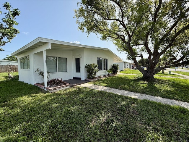 21899 Cellini Ave, Port Charlotte, FL 33952 - view of front of house with a front lawn and stucco siding