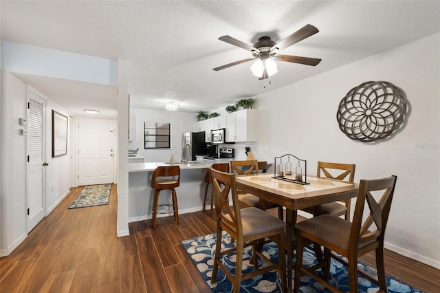 175 Kings Hwy Unit 625, Punta Gorda, FL 33983 - dining room featuring dark wood-style floors, baseboards, and ceiling fan