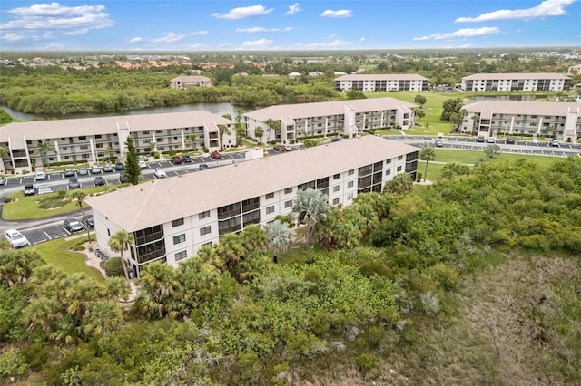 175 Kings Hwy Unit 625, Punta Gorda, FL 33983 - bird's eye view of apartment complex, a tree filled landscape, and a large body of water