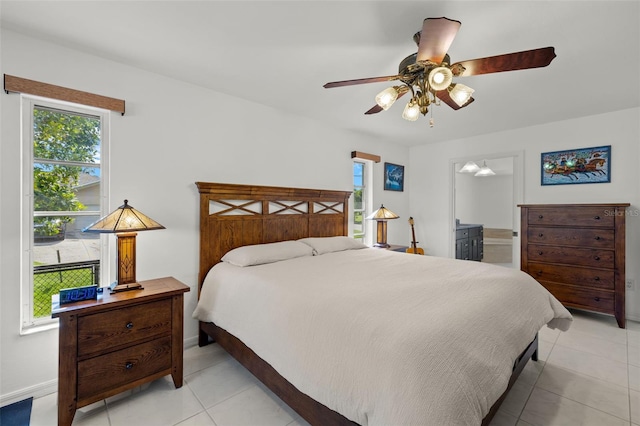 2223 SE 10th Ln, Cape Coral, FL 33990 - bedroom featuring multiple windows, light tile patterned flooring, baseboards, and ceiling fan