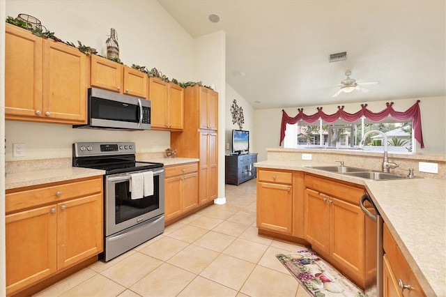 7280 Muncey Rd, North Port, FL 34291 - kitchen with stainless steel appliances, light countertops, light tile patterned floors, a ceiling fan, and vaulted ceiling